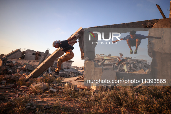 Palestinian youths are playing parkour at the ruins of a building destroyed in recent Israeli air strikes, in Zawayda, in the central Gaza S...