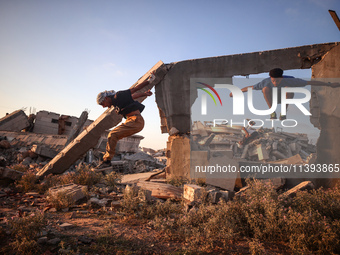 Palestinian youths are playing parkour at the ruins of a building destroyed in recent Israeli air strikes, in Zawayda, in the central Gaza S...