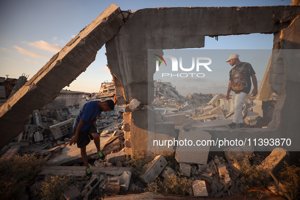 Palestinian youths are playing parkour at the ruins of a building destroyed in recent Israeli air strikes, in Zawayda, in the central Gaza S...