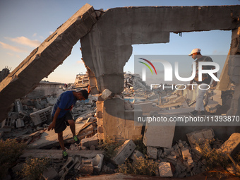 Palestinian youths are playing parkour at the ruins of a building destroyed in recent Israeli air strikes, in Zawayda, in the central Gaza S...