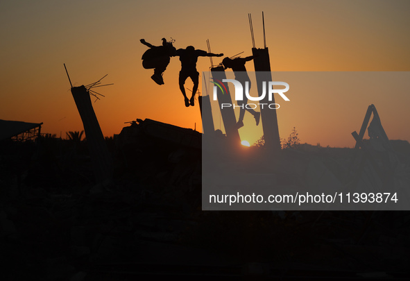 Palestinian youths are playing parkour at the ruins of a building destroyed in recent Israeli air strikes, in Zawayda, in the central Gaza S...