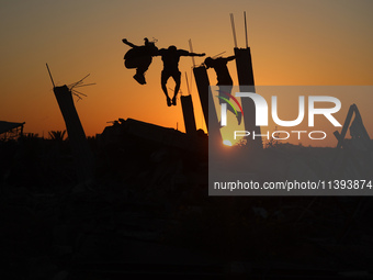 Palestinian youths are playing parkour at the ruins of a building destroyed in recent Israeli air strikes, in Zawayda, in the central Gaza S...