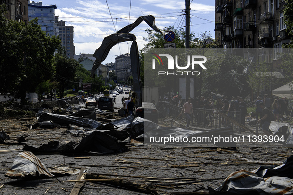 People are walking in a street covered with debris after a Russian missile strike in Kyiv, Ukraine, on July 08, 2024, amid the Russian invas...