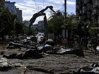 People are walking in a street covered with debris after a Russian missile strike in Kyiv, Ukraine, on July 08, 2024, amid the Russian invas...