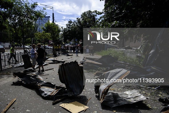 People are walking in a street covered with debris after a Russian missile strike in Kyiv, Ukraine, on July 08, 2024, amid the Russian invas...