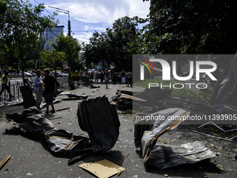 People are walking in a street covered with debris after a Russian missile strike in Kyiv, Ukraine, on July 08, 2024, amid the Russian invas...