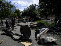 People are walking in a street covered with debris after a Russian missile strike in Kyiv, Ukraine, on July 08, 2024, amid the Russian invas...