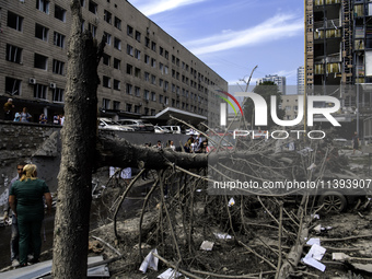 Rescuers and volunteers are working at Ohmatdyt Children's Hospital that was strongly damaged during a Russian missile strike in Kyiv, Ukrai...