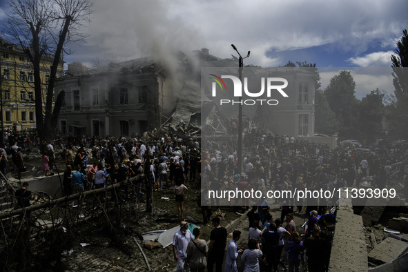 Rescuers and volunteers are working at Ohmatdyt Children's Hospital that was strongly damaged during a Russian missile strike in Kyiv, Ukrai...