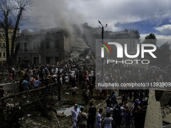 Rescuers and volunteers are working at Ohmatdyt Children's Hospital that was strongly damaged during a Russian missile strike in Kyiv, Ukrai...