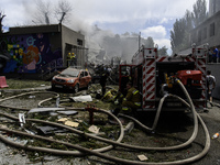 Rescuers and volunteers are working at Ohmatdyt Children's Hospital that was strongly damaged during a Russian missile strike in Kyiv, Ukrai...