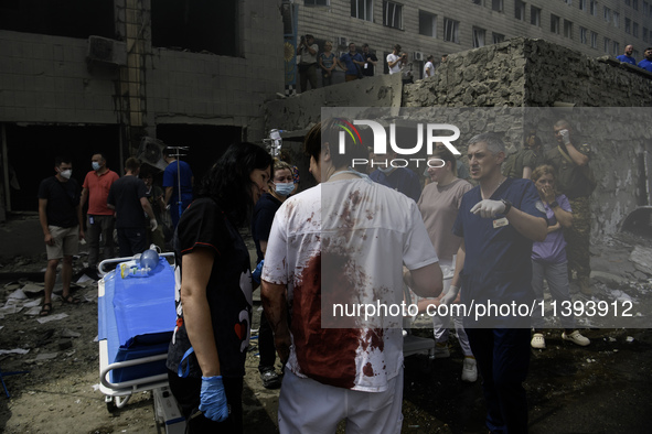 Rescuers and volunteers are working at Ohmatdyt Children's Hospital that was strongly damaged during a Russian missile strike in Kyiv, Ukrai...