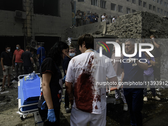 Rescuers and volunteers are working at Ohmatdyt Children's Hospital that was strongly damaged during a Russian missile strike in Kyiv, Ukrai...