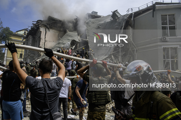 Rescuers and volunteers are working at Ohmatdyt Children's Hospital that was strongly damaged during a Russian missile strike in Kyiv, Ukrai...