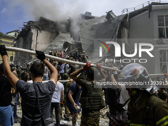 Rescuers and volunteers are working at Ohmatdyt Children's Hospital that was strongly damaged during a Russian missile strike in Kyiv, Ukrai...