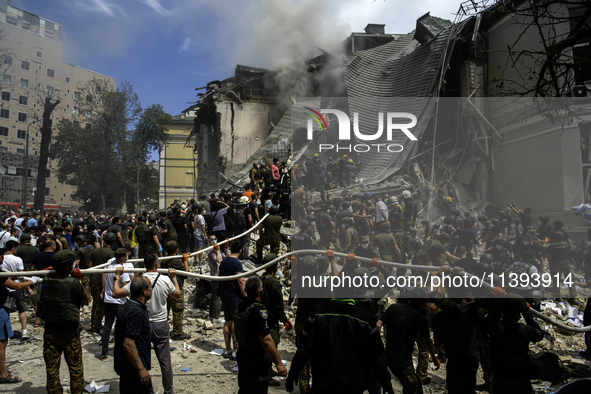 Rescuers and volunteers are working at Ohmatdyt Children's Hospital that was strongly damaged during a Russian missile strike in Kyiv, Ukrai...