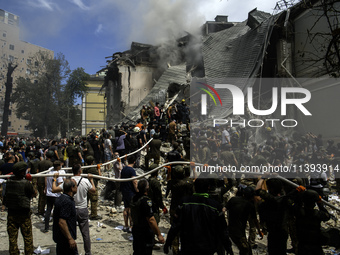 Rescuers and volunteers are working at Ohmatdyt Children's Hospital that was strongly damaged during a Russian missile strike in Kyiv, Ukrai...