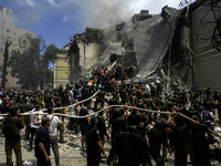 Rescuers and volunteers are working at Ohmatdyt Children's Hospital that was strongly damaged during a Russian missile strike in Kyiv, Ukrai...