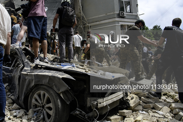 Rescuers and volunteers are working at Ohmatdyt Children's Hospital that was strongly damaged during a Russian missile strike in Kyiv, Ukrai...