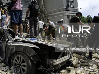 Rescuers and volunteers are working at Ohmatdyt Children's Hospital that was strongly damaged during a Russian missile strike in Kyiv, Ukrai...