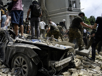 Rescuers and volunteers are working at Ohmatdyt Children's Hospital that was strongly damaged during a Russian missile strike in Kyiv, Ukrai...