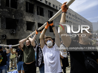 Rescuers and volunteers are working at Ohmatdyt Children's Hospital that was strongly damaged during a Russian missile strike in Kyiv, Ukrai...