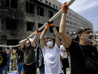 Rescuers and volunteers are working at Ohmatdyt Children's Hospital that was strongly damaged during a Russian missile strike in Kyiv, Ukrai...