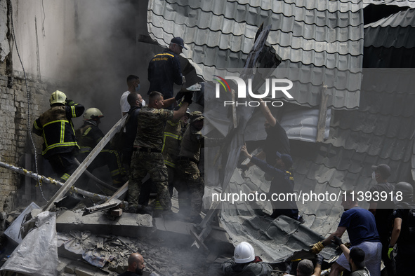 Rescuers and volunteers are working at Ohmatdyt Children's Hospital that was strongly damaged during a Russian missile strike in Kyiv, Ukrai...