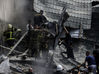 Rescuers and volunteers are working at Ohmatdyt Children's Hospital that was strongly damaged during a Russian missile strike in Kyiv, Ukrai...