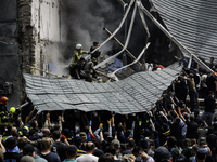 Rescuers and volunteers are working at Ohmatdyt Children's Hospital that was strongly damaged during a Russian missile strike in Kyiv, Ukrai...