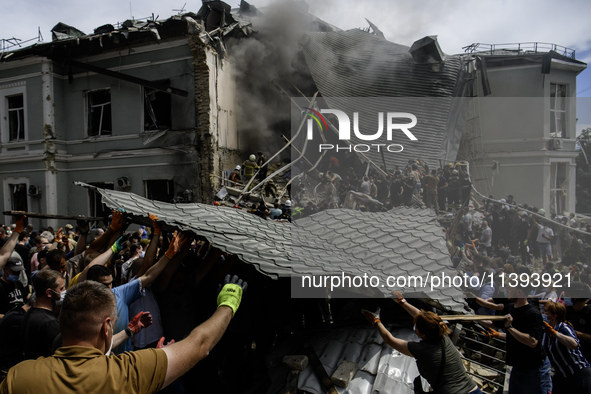 Rescuers and volunteers are working at Ohmatdyt Children's Hospital that was strongly damaged during a Russian missile strike in Kyiv, Ukrai...