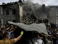 Rescuers and volunteers are working at Ohmatdyt Children's Hospital that was strongly damaged during a Russian missile strike in Kyiv, Ukrai...