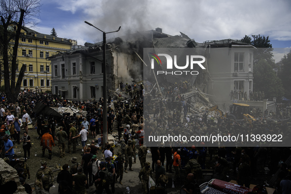 Rescuers and volunteers are working at Ohmatdyt Children's Hospital that was strongly damaged during a Russian missile strike in Kyiv, Ukrai...