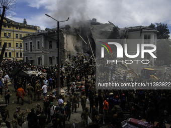 Rescuers and volunteers are working at Ohmatdyt Children's Hospital that was strongly damaged during a Russian missile strike in Kyiv, Ukrai...