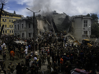 Rescuers and volunteers are working at Ohmatdyt Children's Hospital that was strongly damaged during a Russian missile strike in Kyiv, Ukrai...