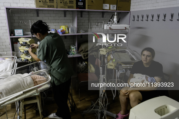 Doctors and parents with newborn babies are taking shelter during another air raid alarm in one of the buildings of Ohmatdyt Children's Hosp...