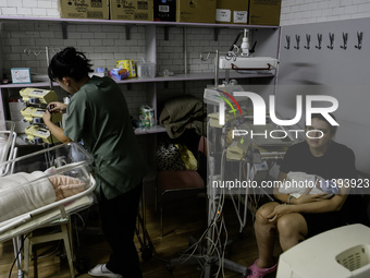 Doctors and parents with newborn babies are taking shelter during another air raid alarm in one of the buildings of Ohmatdyt Children's Hosp...