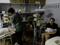 Doctors and parents with newborn babies are taking shelter during another air raid alarm in one of the buildings of Ohmatdyt Children's Hosp...