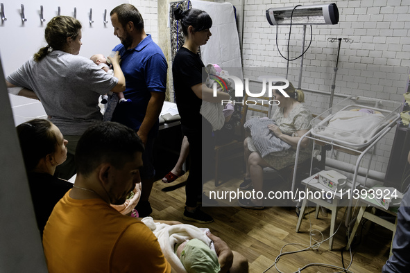 Doctors and parents with newborn babies are taking shelter during another air raid alarm in one of the buildings of Ohmatdyt Children's Hosp...