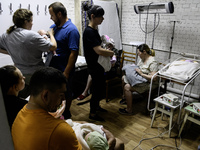 Doctors and parents with newborn babies are taking shelter during another air raid alarm in one of the buildings of Ohmatdyt Children's Hosp...