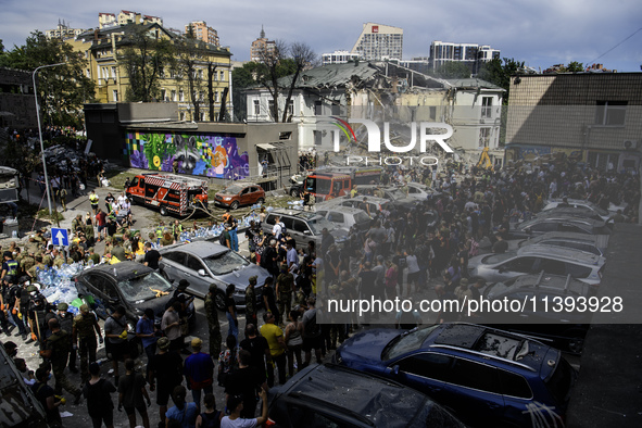 Rescuers and volunteers are working at Ohmatdyt Children's Hospital that was strongly damaged during a Russian missile strike in Kyiv, Ukrai...