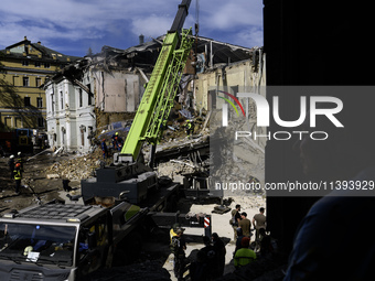 Rescuers and volunteers are working at Ohmatdyt Children's Hospital that was strongly damaged during a Russian missile strike in Kyiv, Ukrai...