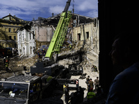 Rescuers and volunteers are working at Ohmatdyt Children's Hospital that was strongly damaged during a Russian missile strike in Kyiv, Ukrai...