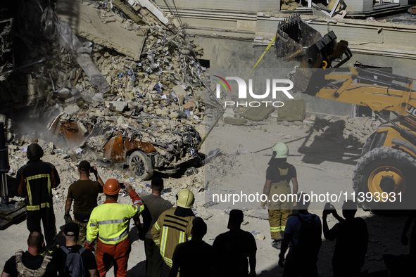 Rescuers and volunteers are working at Ohmatdyt Children's Hospital that was strongly damaged during a Russian missile strike in Kyiv, Ukrai...