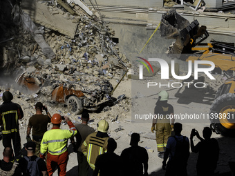 Rescuers and volunteers are working at Ohmatdyt Children's Hospital that was strongly damaged during a Russian missile strike in Kyiv, Ukrai...