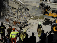 Rescuers and volunteers are working at Ohmatdyt Children's Hospital that was strongly damaged during a Russian missile strike in Kyiv, Ukrai...