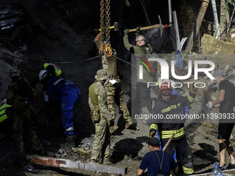 Rescuers and volunteers are working at Ohmatdyt Children's Hospital that was strongly damaged during a Russian missile strike in Kyiv, Ukrai...