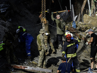 Rescuers and volunteers are working at Ohmatdyt Children's Hospital that was strongly damaged during a Russian missile strike in Kyiv, Ukrai...