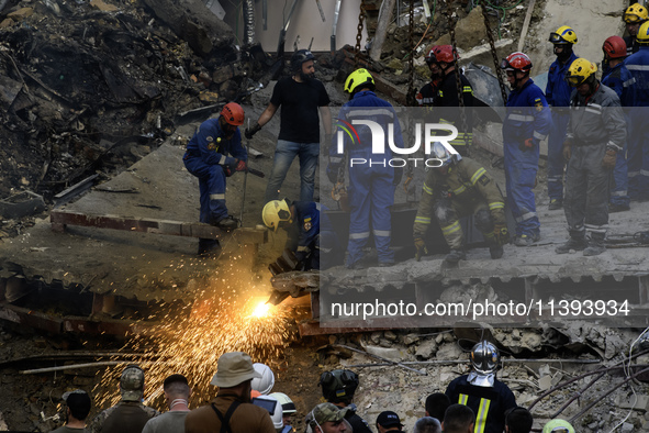 Rescuers and volunteers are working at Ohmatdyt Children's Hospital that was strongly damaged during a Russian missile strike in Kyiv, Ukrai...