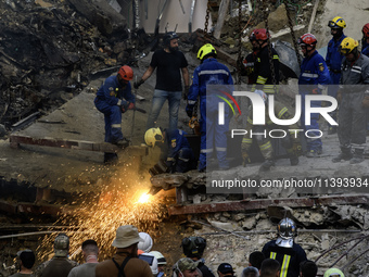 Rescuers and volunteers are working at Ohmatdyt Children's Hospital that was strongly damaged during a Russian missile strike in Kyiv, Ukrai...